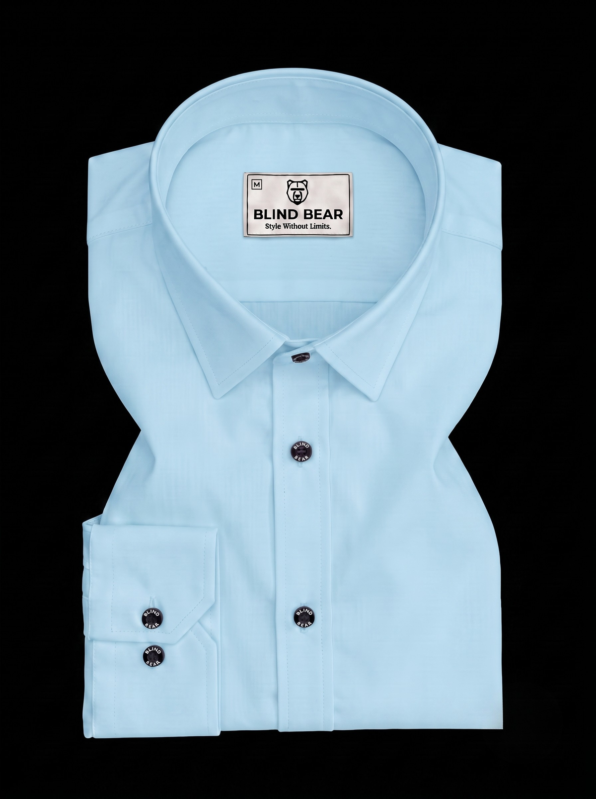 A light blue long-sleeve dress shirt by Blind Bear, neatly folded and displayed against a solid black background.