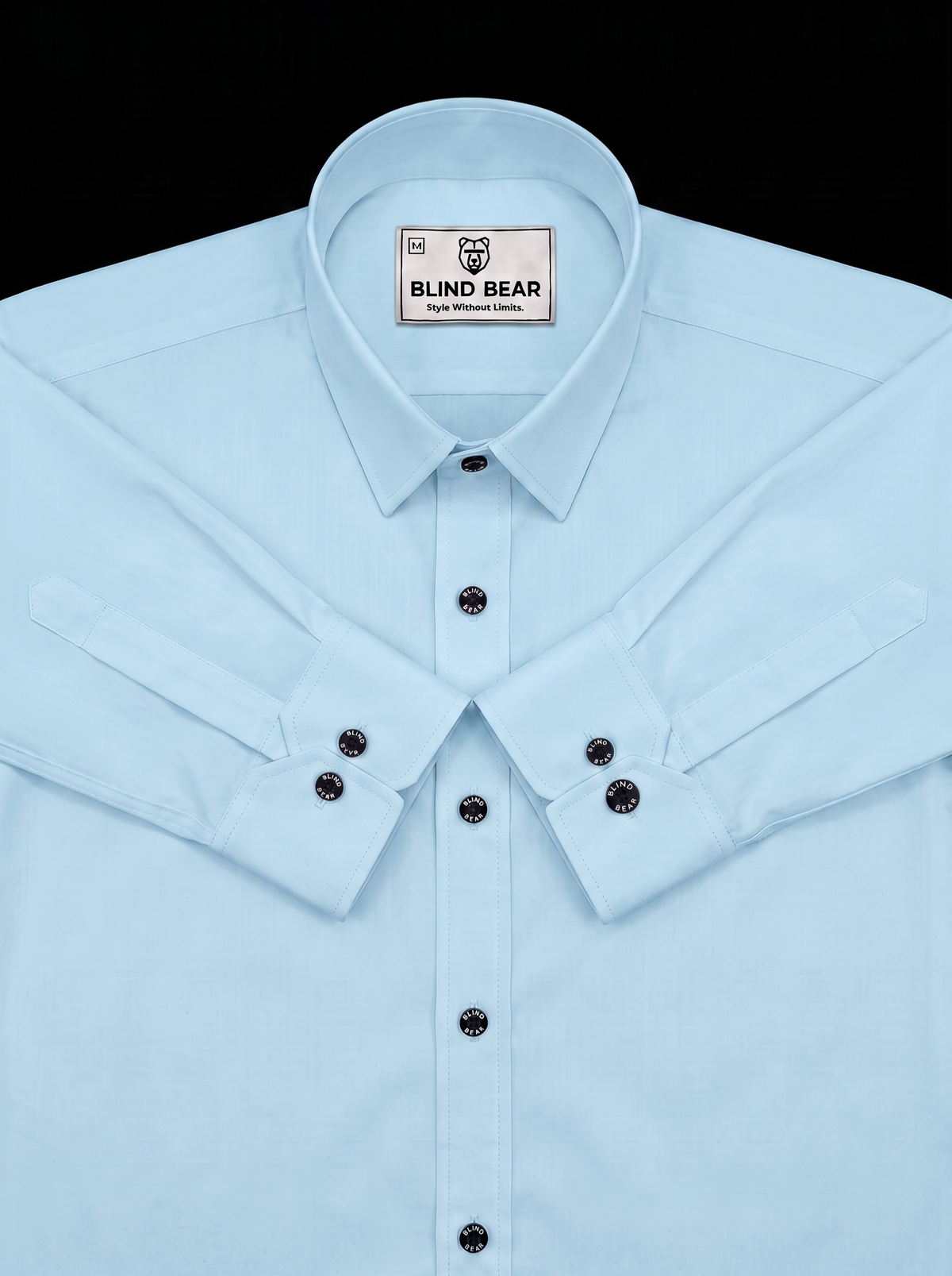 A light blue long-sleeve button-down shirt by Blind Bear, featuring a pointed collar, a rectangular neck label with the brand name, and double-buttoned cuffs.